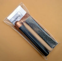 reverse side showing flintknapping tools in copper bopper knap pack