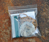 pouch containing survival fire making magnesium kit
