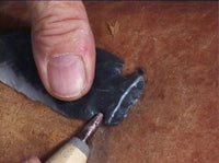 notching flint spearhead with pressure flaker