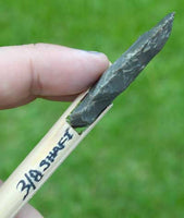 cross view of stone arrowhead on shaft
