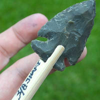 Hand knapped stone arrowhead on shaft