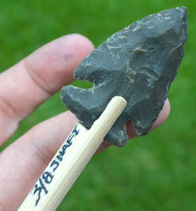 Hand knapped stone arrowhead on shaft