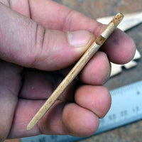 side view of hand carved bone arrow points