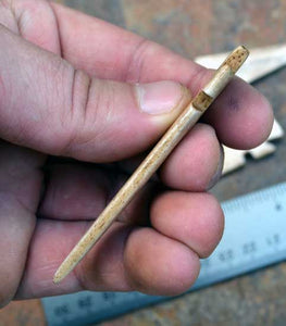 side view of hand carved bone arrow points