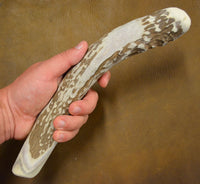 position in hand of extra large antler percussion flintknapping billet tool
