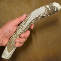position in hand of extra large antler percussion flintknapping billet tool