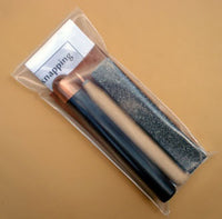 reverse side showing flintknapping tools in copper bopper knap pack
