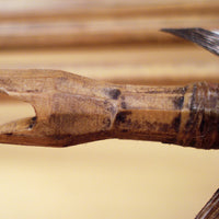 side view of hand carved nock and hafting of traditional arrow