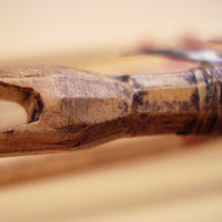 close up of hand carved nock on traditional arrow
