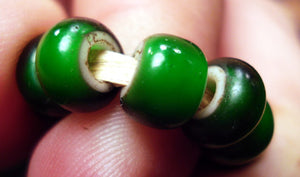 Close up of detail of green white heart beads