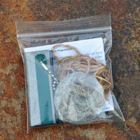 pouch containing survival fire making magnesium kit