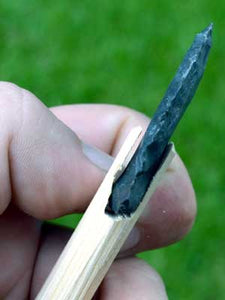 side view of stone arrowhead fitment on shaft