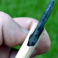 attachment of indian stone arrowhead on shaft