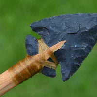 hafted stone indian arrowhead on shaft